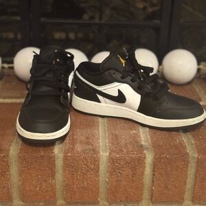 Jordan’s Nike Black and White Sneakers with Gold Accents